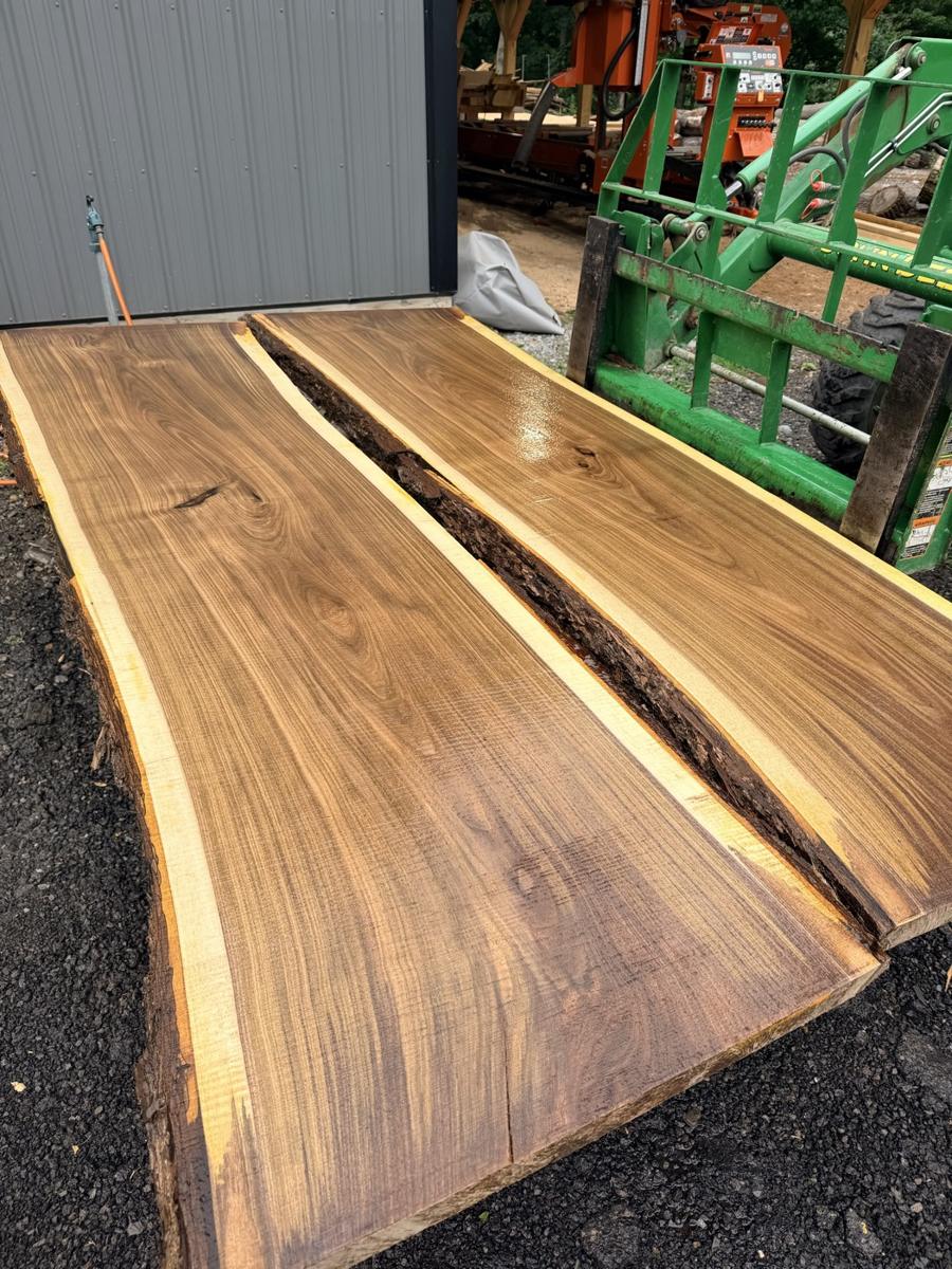 A kiln-dried black walnut live-edge slab with both edges left natural